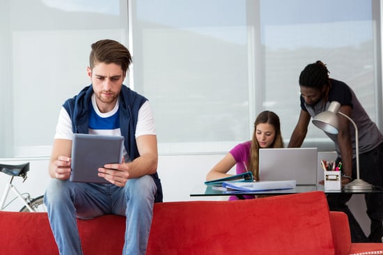 Coworking space and a founder with digital tablet and laptop