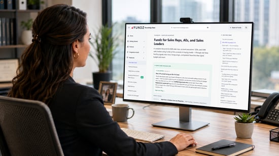 Business customer reviewing a Fundz knowledge base playbook on her office computer while learning how to use sales training resources and workflow guidance.