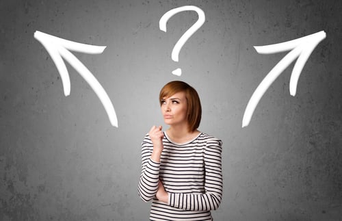 Pretty young woman making a decision with arrows and question mark above her head-1