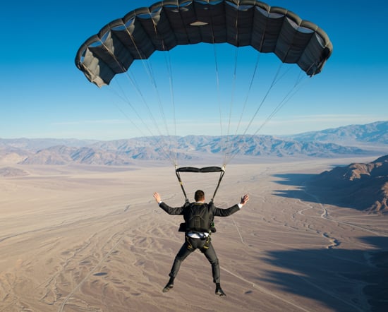 Video screenshot of an edit of a businessman in a suit skydiving