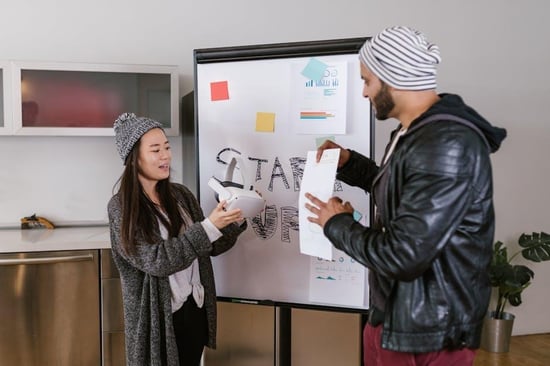 Modern startup office with moving boxes and whiteboard transition plans