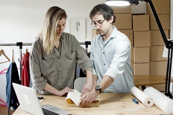Startup team packing up office equipment during a company relocation